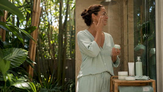 Woman moisturizing smooth, glowing skin after a Silk and Glow body polish at Lumina Skin Sanctuary in Fort Myers, Florida
